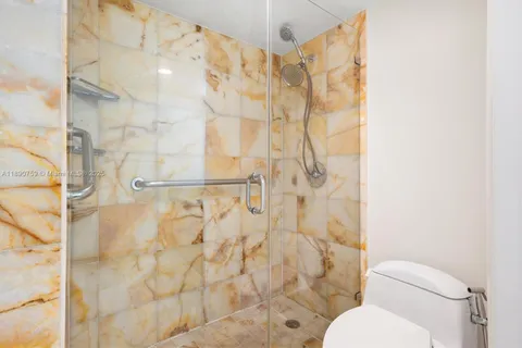 a white toilet sitting next to a shower curtain