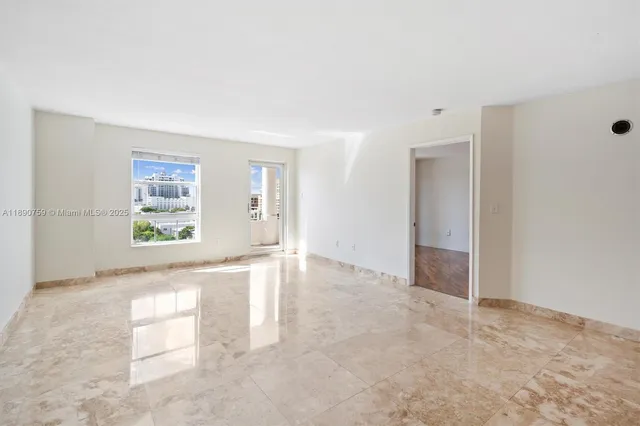 an empty room with windows and closet