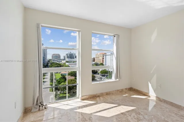 a view of a room that has a bed and a window