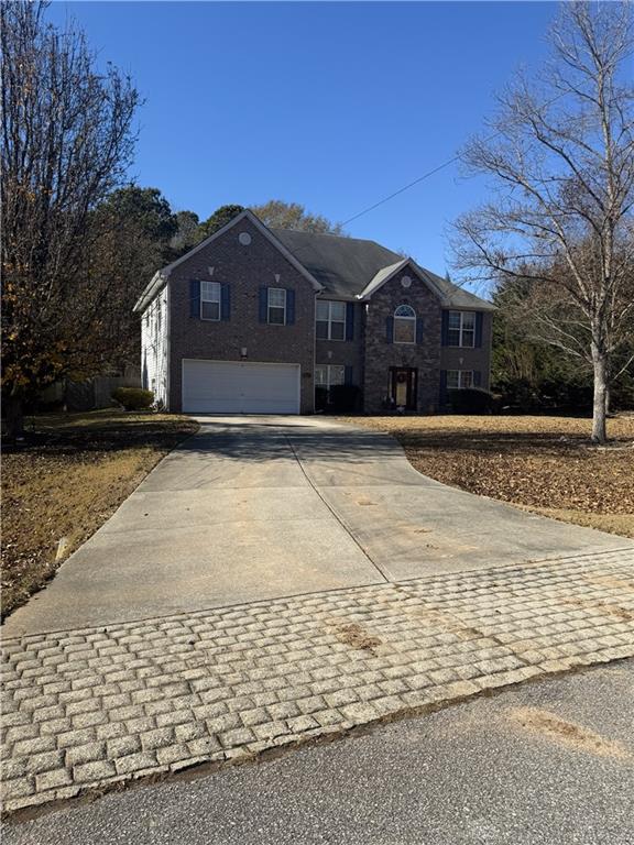 829 Sweden Forest Cove Hampton, GA 30228 - Photo 2 of 9 a front view of a house with a yard