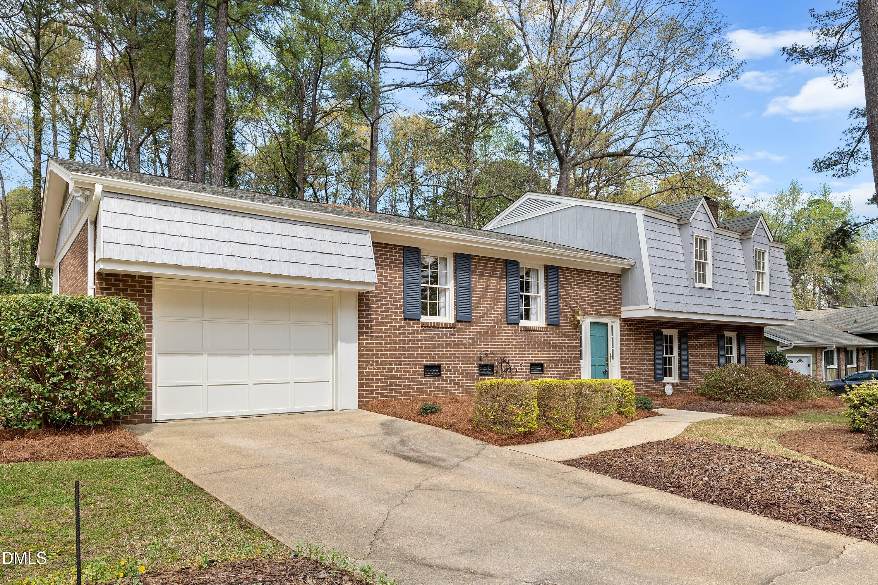 1429 Falls Church Road Raleigh, NC 27609 - Photo 6 of 60 a front view of a house with a yard and garage