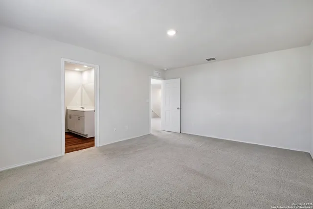 a view of an empty room and a window