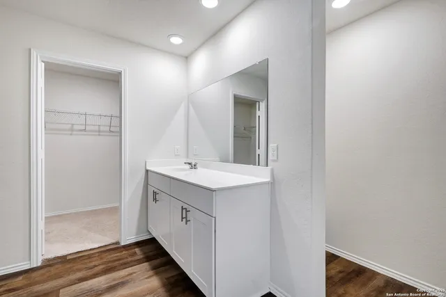 a bathroom with a double vanity sink and mirror