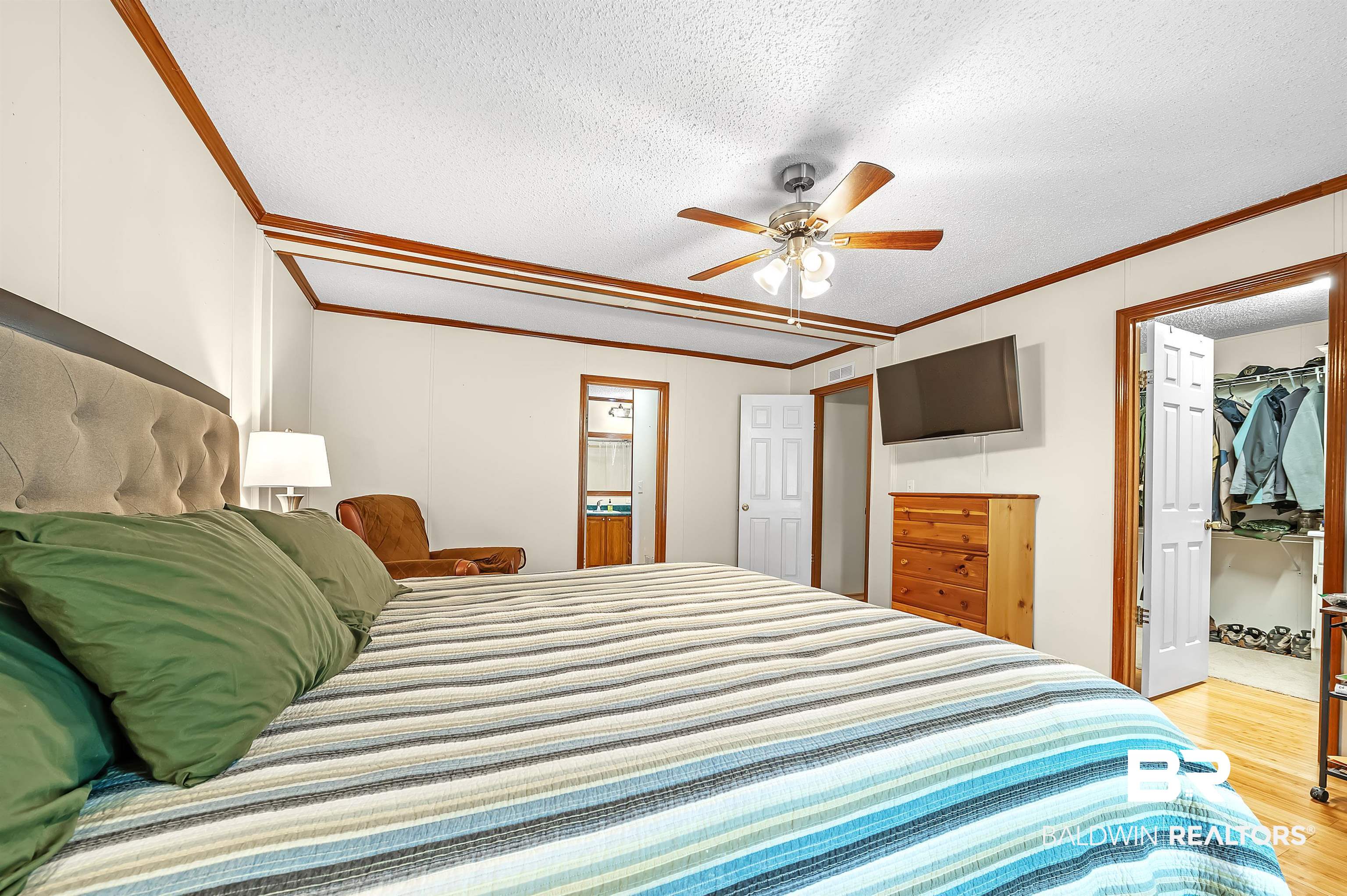 10970 Stucki Road Elberta, AL 36530 - Photo 27 of 56 Bedroom with Bamboo flooring, a textured ceiling, ceiling fan, a walk in closet, and a closet