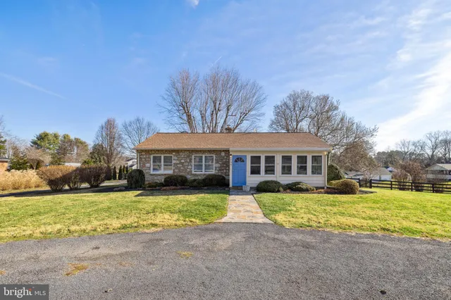 a view of a house with swimming pool and a yard
