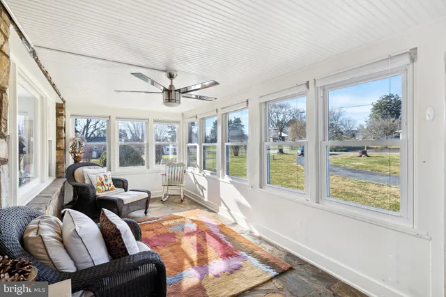 a living room with furniture and floor to ceiling windows