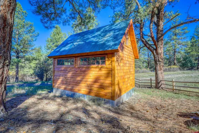 a view of a backyard with large trees