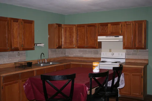a living room with furniture and a ceiling fan