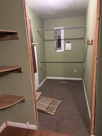 a room with a wooden floor and a window