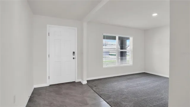 a view of an empty room with a window