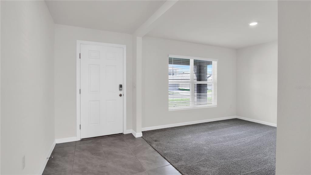 16632 Windmill Forge Pass Wimauma, FL 33598 - Photo 11 of 40 a view of an empty room with a window