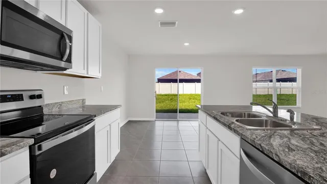 a kitchen with refrigerator and cabinets