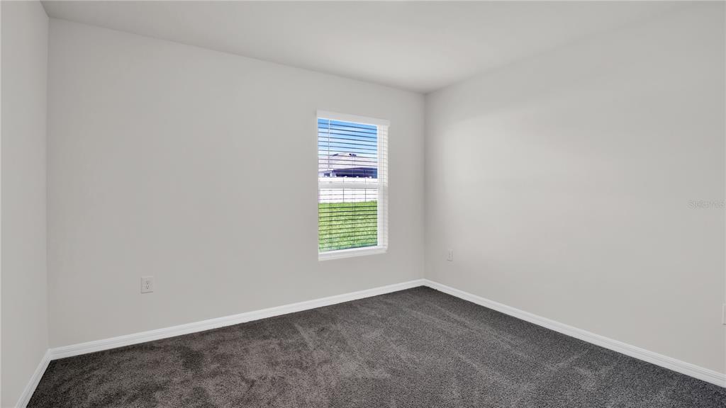 16632 Windmill Forge Pass Wimauma, FL 33598 - Photo 23 of 40 an empty room with a window