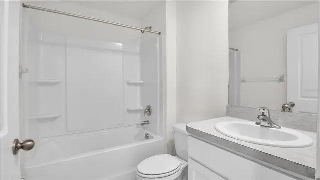a view of a kitchen with a sink and a refrigerator