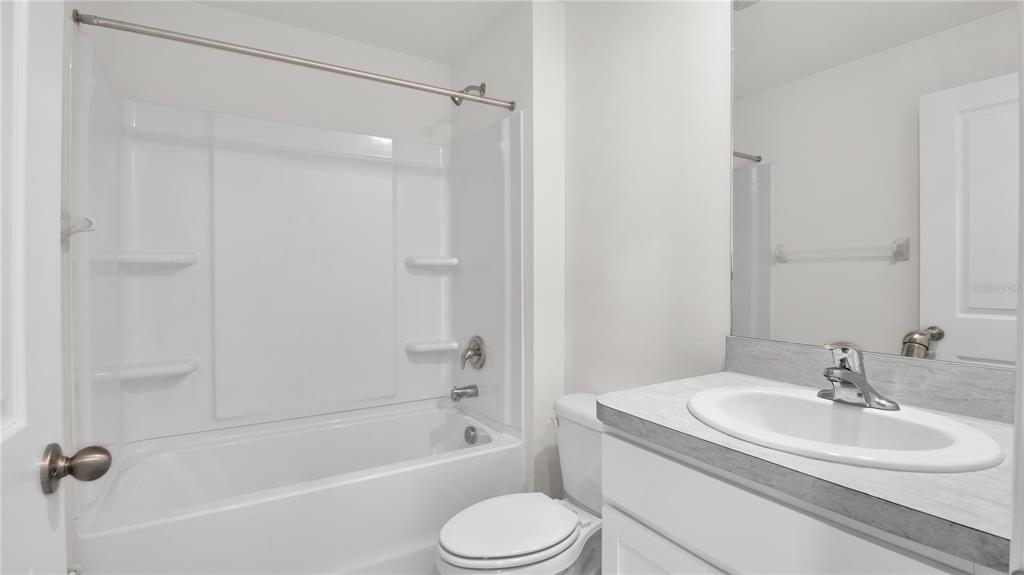 16632 Windmill Forge Pass Wimauma, FL 33598 - Photo 25 of 40 a bathroom with a sink toilet and shower