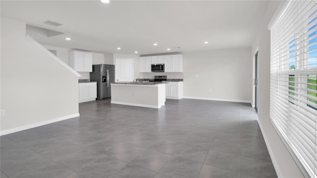 16632 Windmill Forge Pass Wimauma, FL 33598 - Photo 26 of 40 a view of a kitchen with a sink and a refrigerator