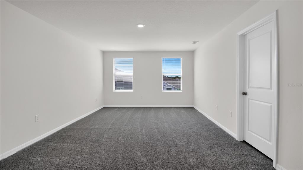16632 Windmill Forge Pass Wimauma, FL 33598 - Photo 27 of 40 an empty room with windows