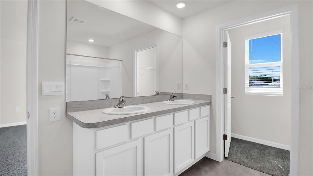 16632 Windmill Forge Pass Wimauma, FL 33598 - Photo 29 of 40 a bathroom with a sink and a mirror