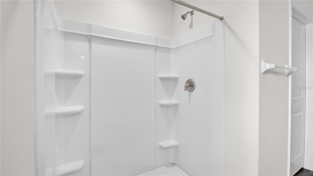 16632 Windmill Forge Pass Wimauma, FL 33598 - Photo 32 of 40 a bathroom with a shower and toilet