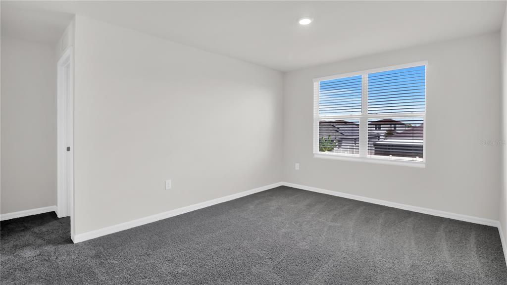 16632 Windmill Forge Pass Wimauma, FL 33598 - Photo 36 of 40 a view of an empty room with a window
