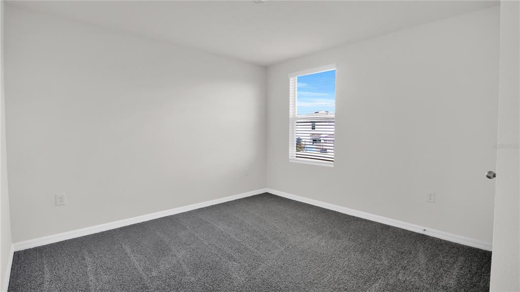 16632 Windmill Forge Pass Wimauma, FL 33598 - Photo 38 of 40 an empty room with a window