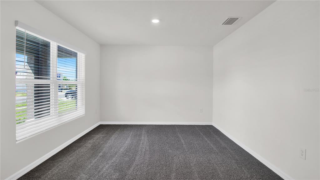 16632 Windmill Forge Pass Wimauma, FL 33598 - Photo 10 of 40 wooden floor in an empty room with a window