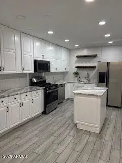 a kitchen with a sink a microwave and cabinets