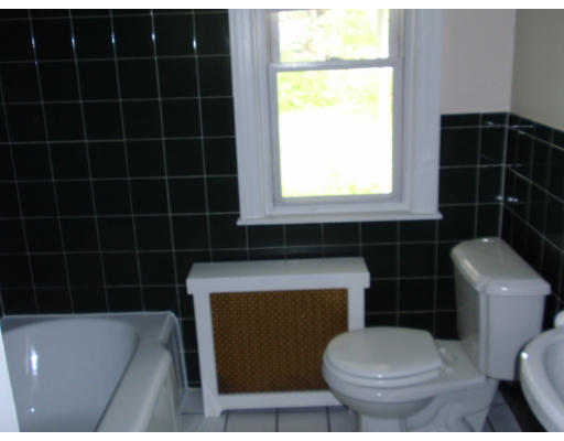 23 Drexel Street Springfield, MA 01104 - Photo 8 of 9 a bathroom with a toilet a sink and a window