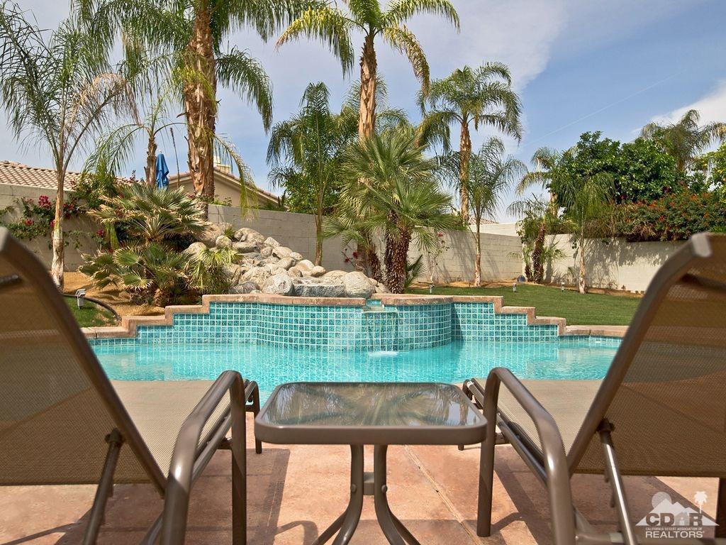 5 Victoria Falls Drive Rancho Mirage, CA 92270 - Photo 7 of 26 a view of a chairs and table in patio next to a yard