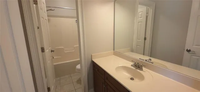 a bathroom with a sink vanity granite shower and a mirror