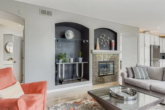 a living room with furniture and a fireplace
