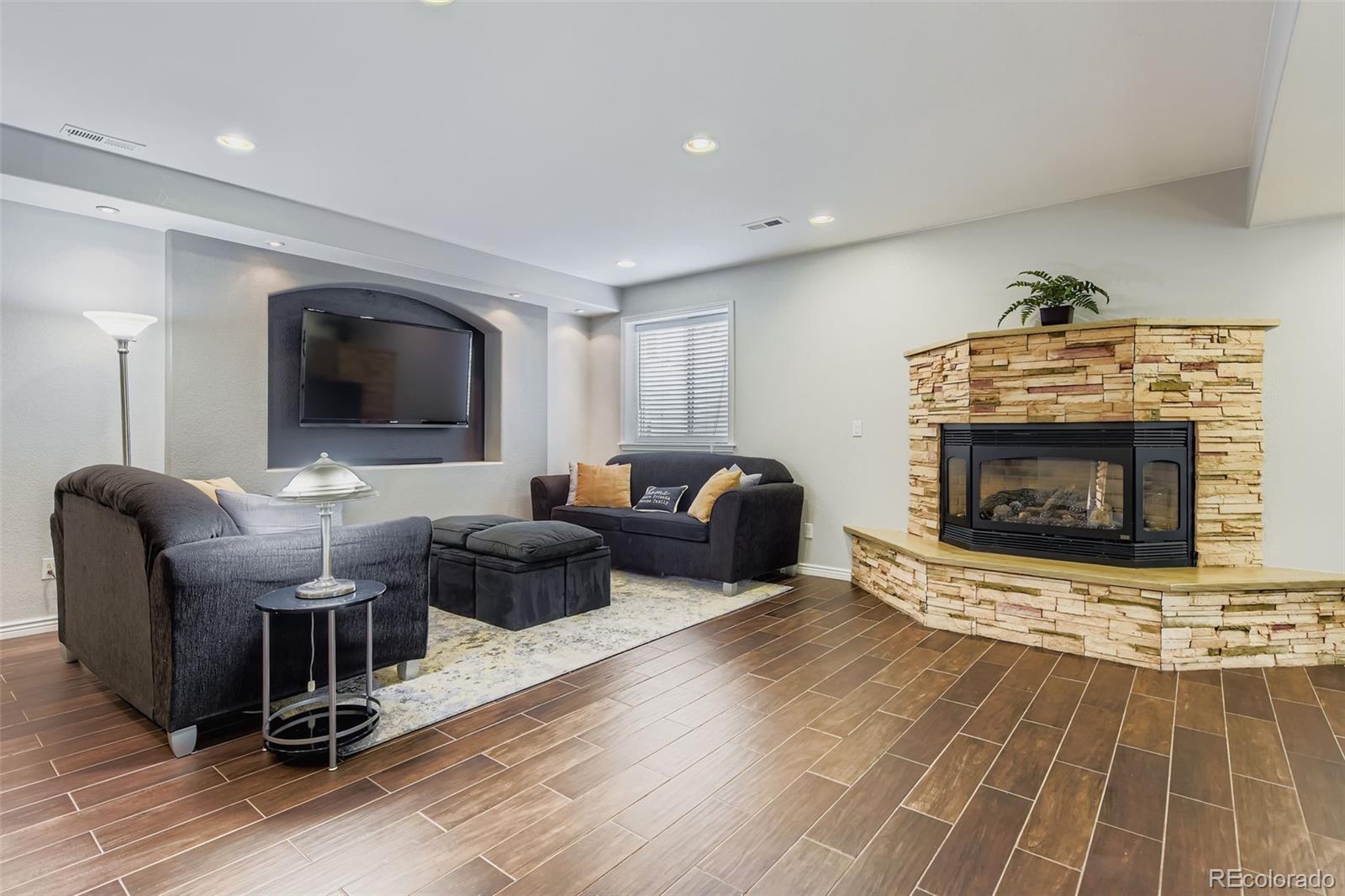 795 Ridgemont Circle Highlands Ranch, CO 80126 - Photo 20 of 35 a living room with furniture and a fireplace