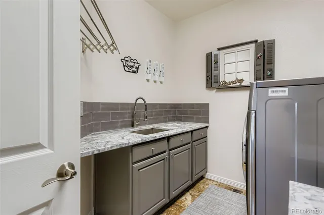 a kitchen with stainless steel appliances granite countertop a sink and refrigerator