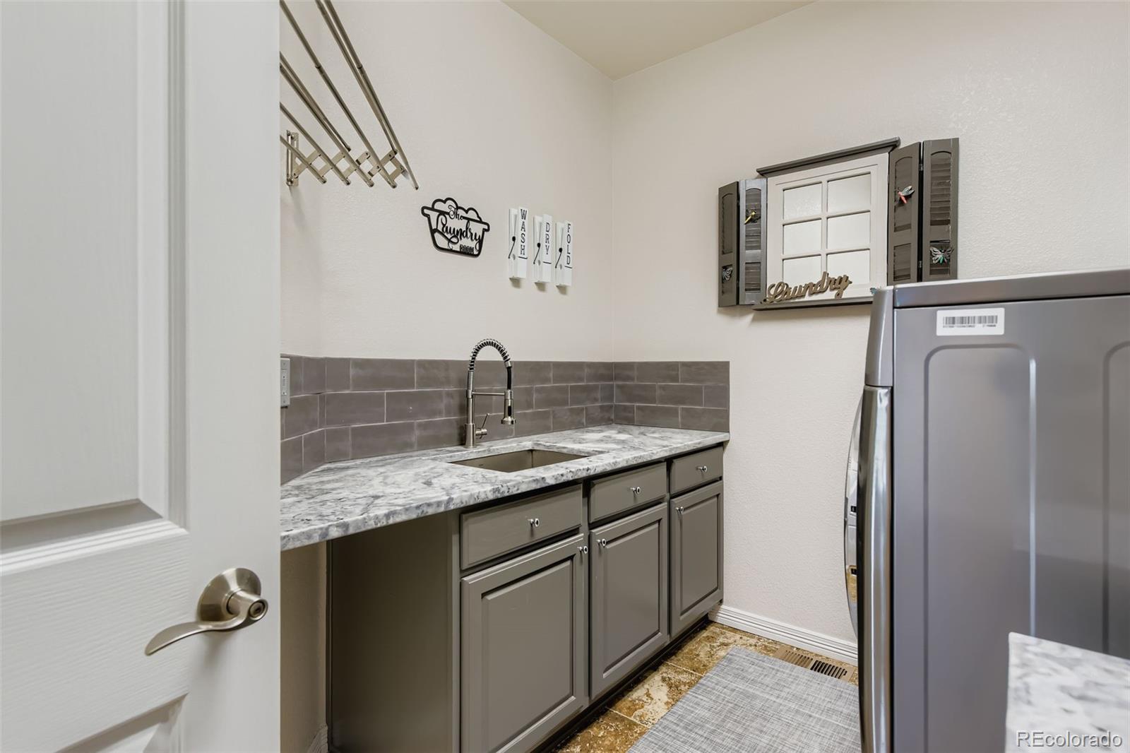 795 Ridgemont Circle Highlands Ranch, CO 80126 - Photo 25 of 35 a kitchen with stainless steel appliances granite countertop a sink and refrigerator