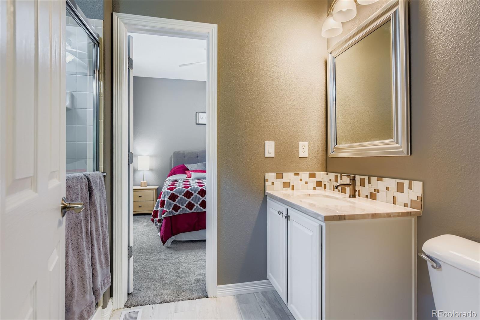 795 Ridgemont Circle Highlands Ranch, CO 80126 - Photo 26 of 35 a bathroom with a sink and mirror with toilet