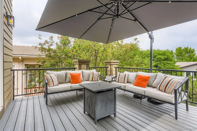 a outdoor sitting area with furniture and wooden floor