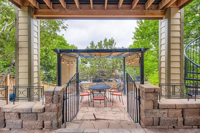 a view of a porch with a table and chairs