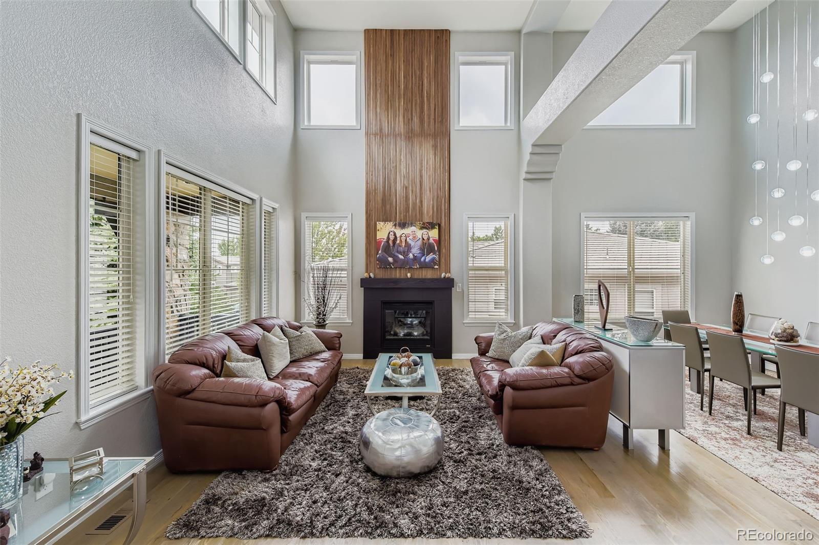 795 Ridgemont Circle Highlands Ranch, CO 80126 - Photo 5 of 35 a living room with furniture a fireplace and a large window