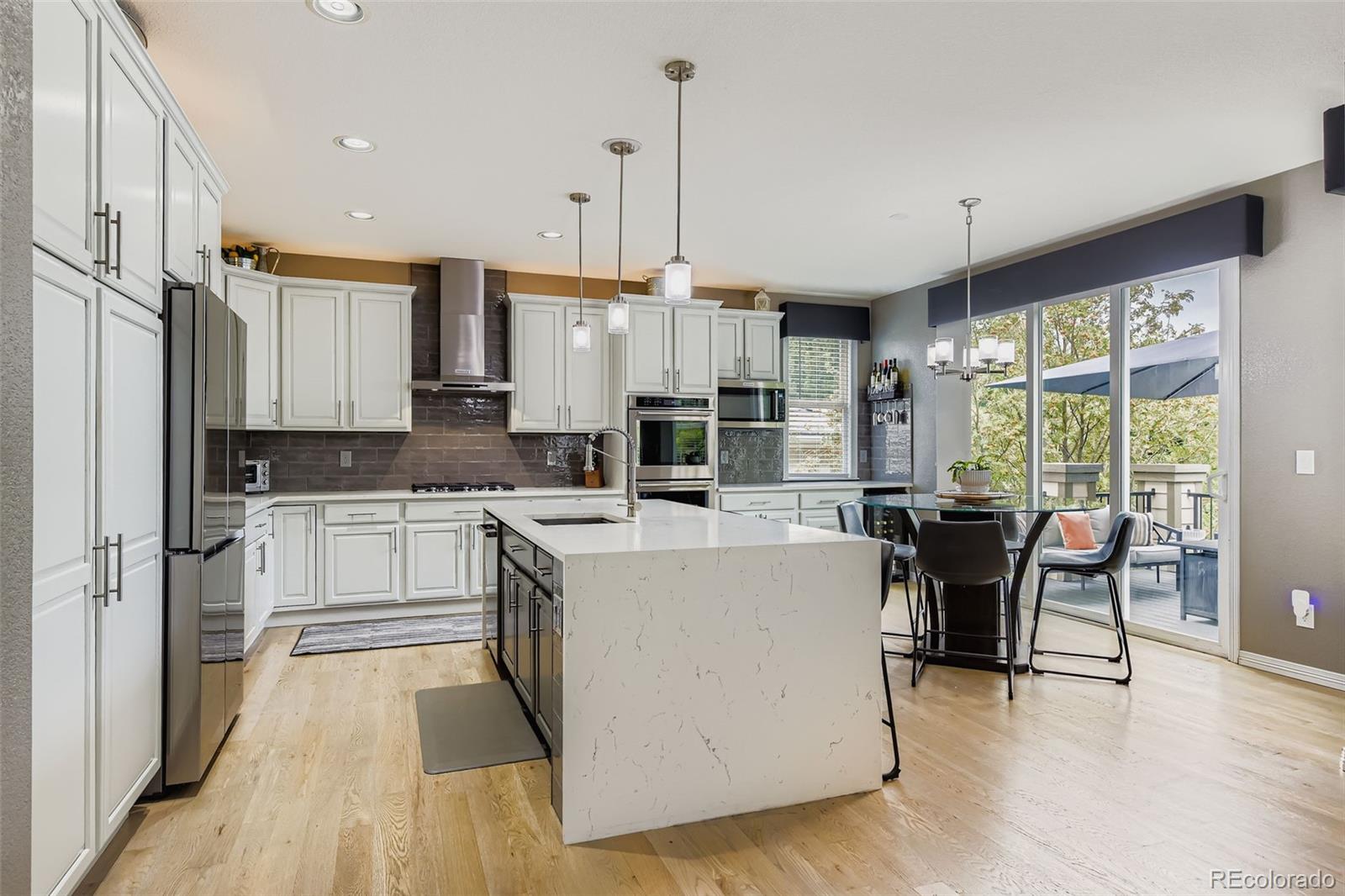 795 Ridgemont Circle Highlands Ranch, CO 80126 - Photo 8 of 35 a large kitchen with kitchen island a large island in it