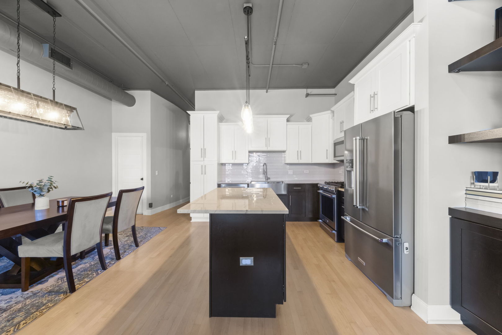 1301 West Madison Street, Unit 305 Chicago, IL 60607 - Photo 5 of 22 a kitchen with kitchen island a counter space a sink appliances and cabinets