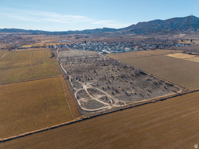 3073 West 500 South Vernal, UT 84078 - Photo 4 of 8 Aerial view of sparsely populated area featuring mountains and rows of crops