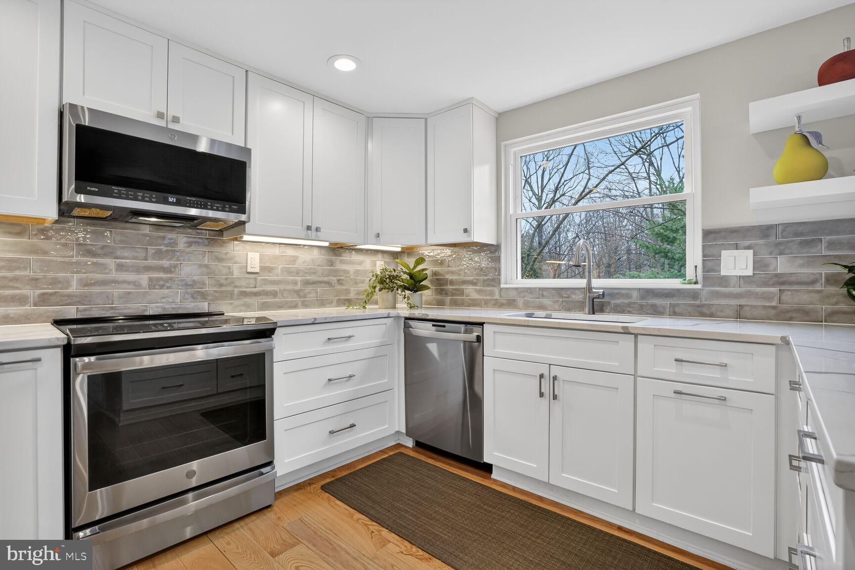 1575 Bennington Woods Court Reston, VA 20194 - Photo 11 of 39 a kitchen with stainless steel appliances white cabinets granite counter tops and a window