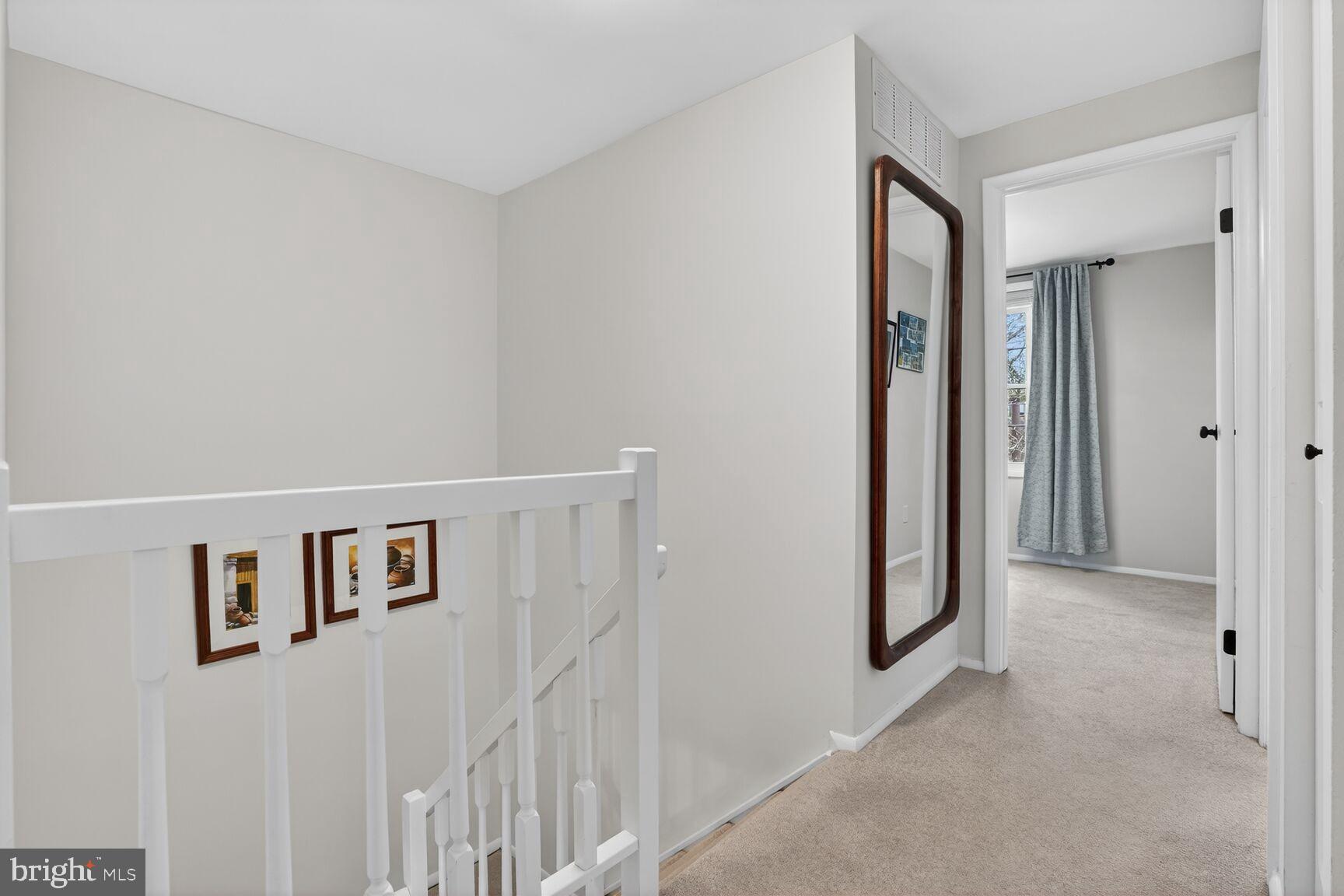 1575 Bennington Woods Court Reston, VA 20194 - Photo 17 of 39 a view of a hallway with paintings on the wall