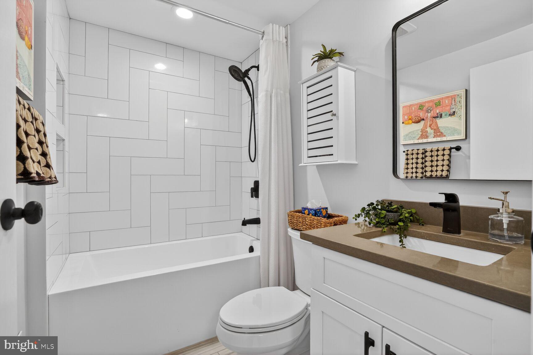 1575 Bennington Woods Court Reston, VA 20194 - Photo 24 of 39 a bathroom with a sink a toilet a mirror a vanity a bath tub and shower