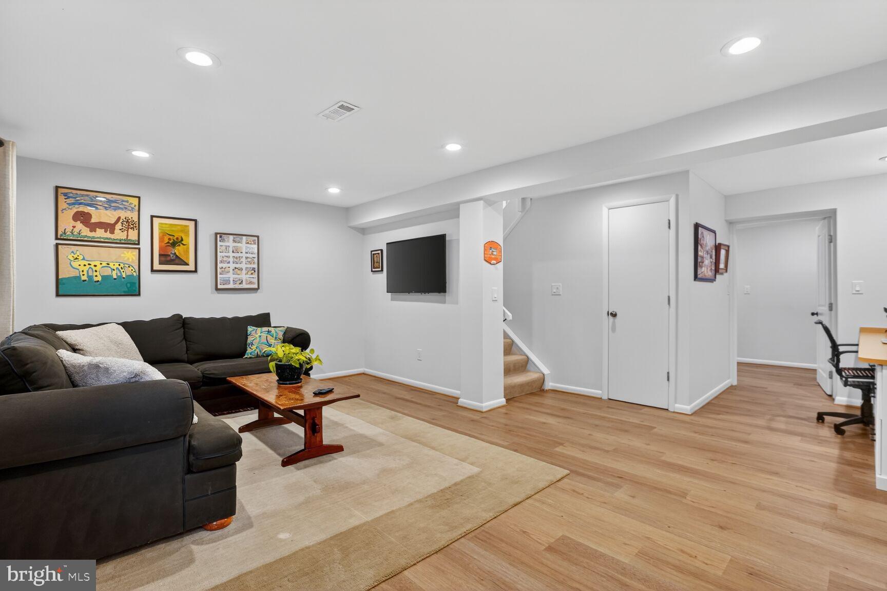 1575 Bennington Woods Court Reston, VA 20194 - Photo 27 of 39 a living room with furniture and a flat screen tv