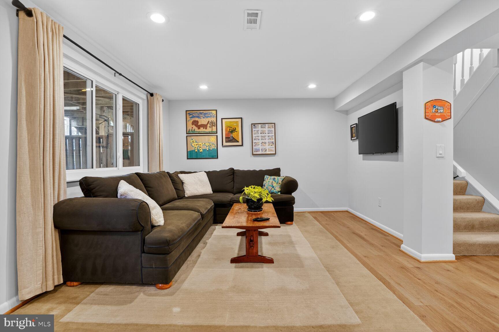 1575 Bennington Woods Court Reston, VA 20194 - Photo 28 of 39 a living room with furniture and a flat screen tv