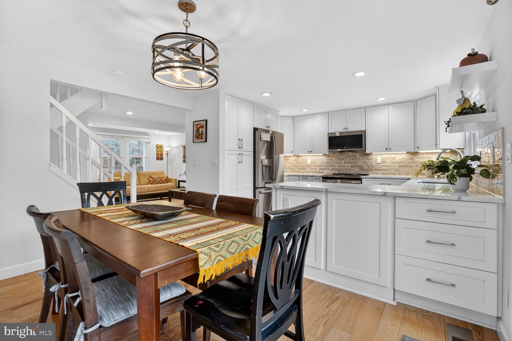 1575 Bennington Woods Court Reston, VA 20194 - Photo 9 of 39 a view of kitchen with sink dining table and chairs