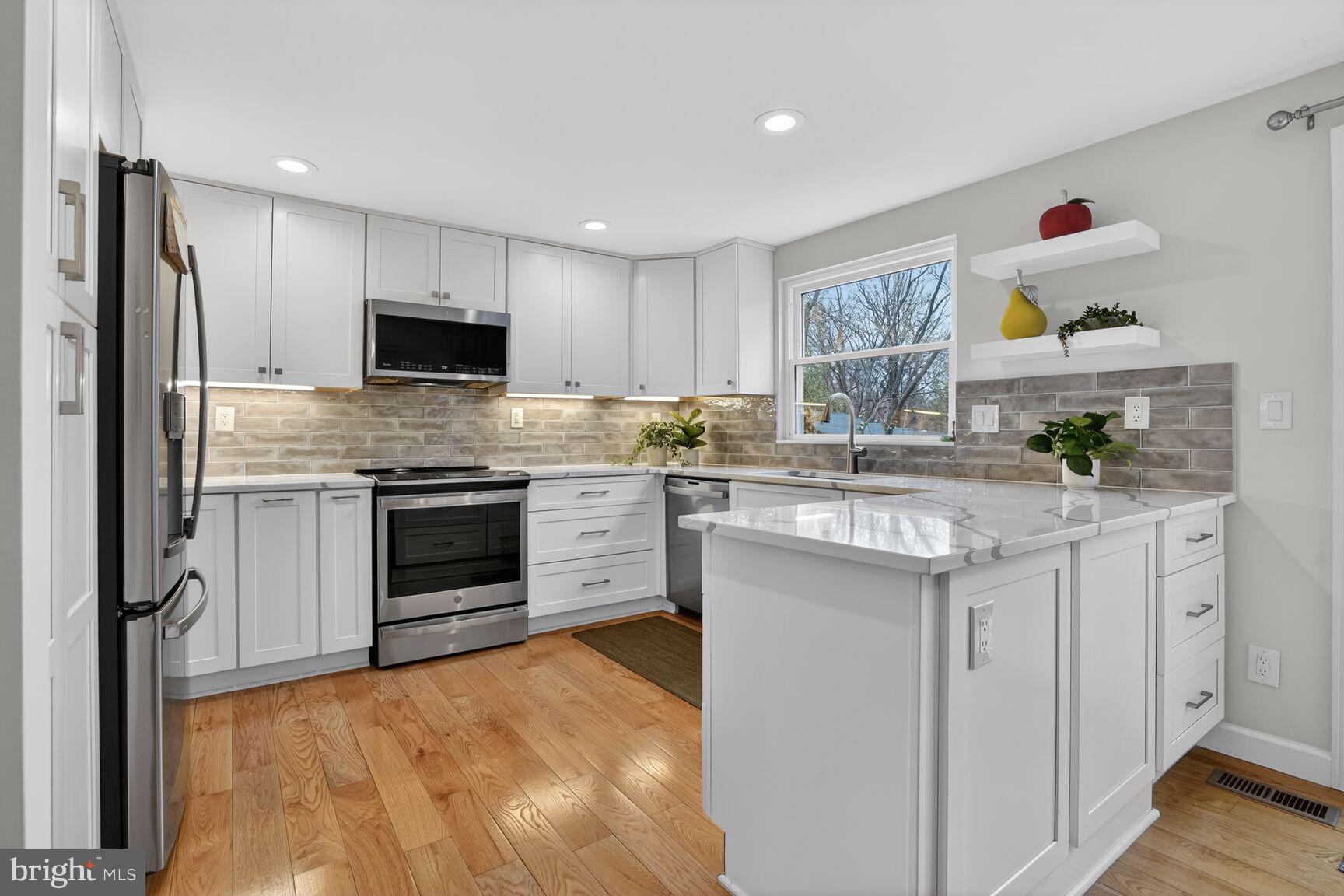 1575 Bennington Woods Court Reston, VA 20194 - Photo 10 of 39 a kitchen with stainless steel appliances a stove sink and cabinets