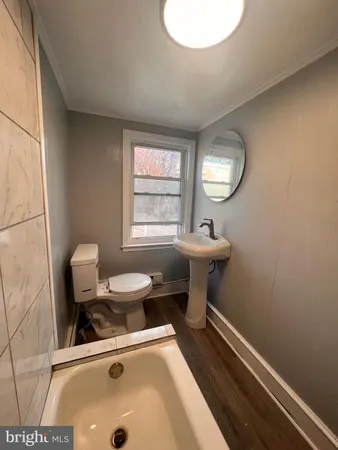 a bathroom with a sink mirror and toilet