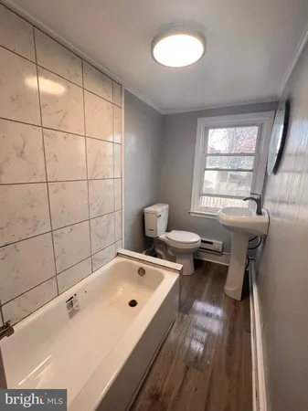 a bathroom with a tub and a sink